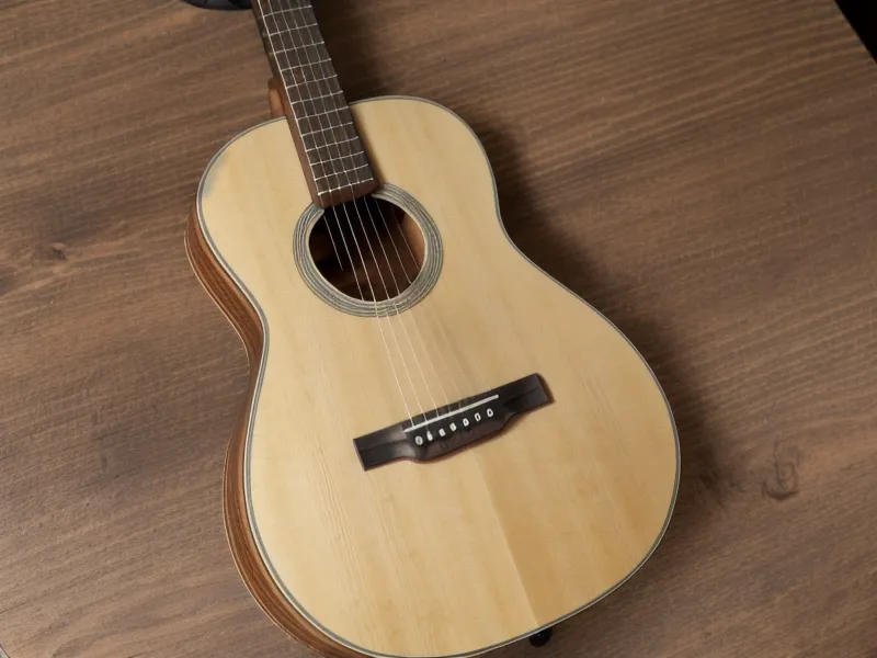 Afinador digital en smartphone marcando 440 Hz junto a la guitarra